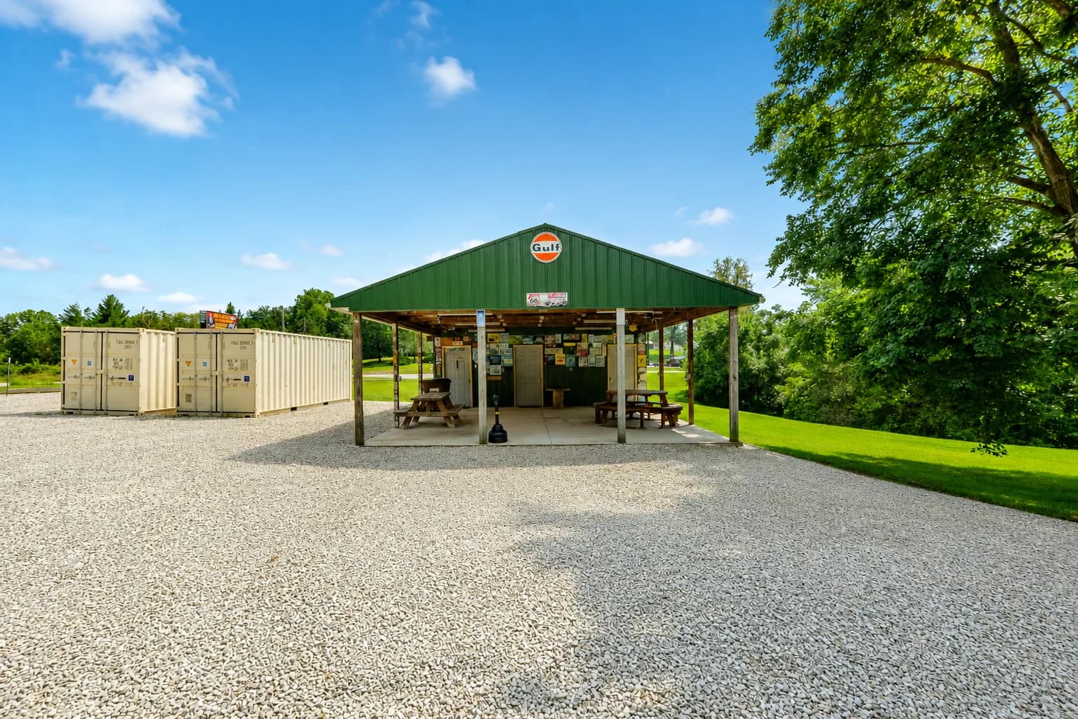 Covered outdoor pavilion with picnic tables and a green metal roof