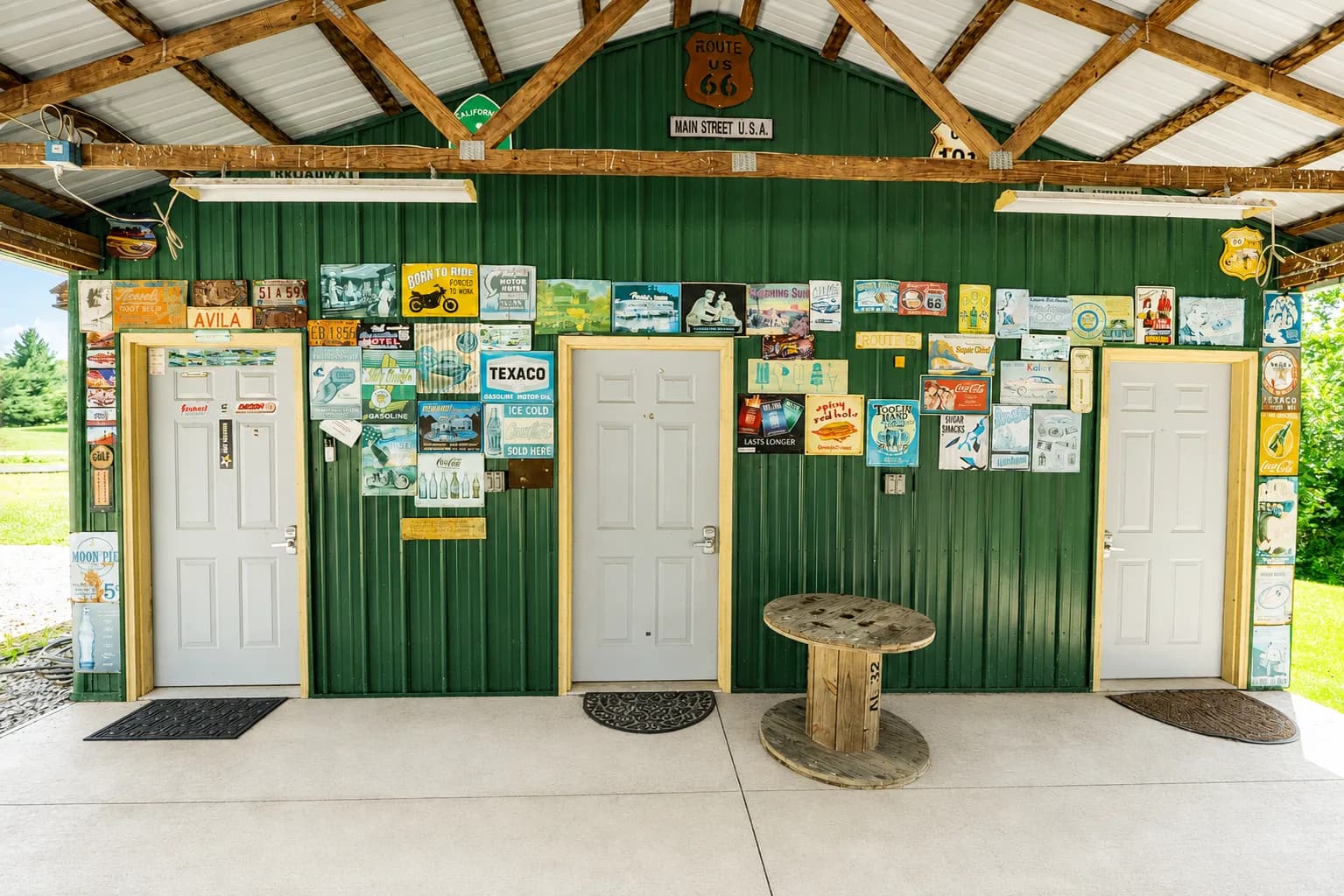 Inside the pavilion, walls covered with vintage road signs and license plates