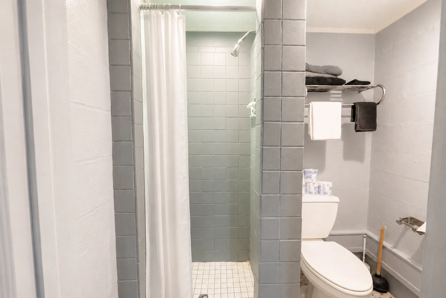 Private bathroom with a tiled walk-in shower and fresh towels