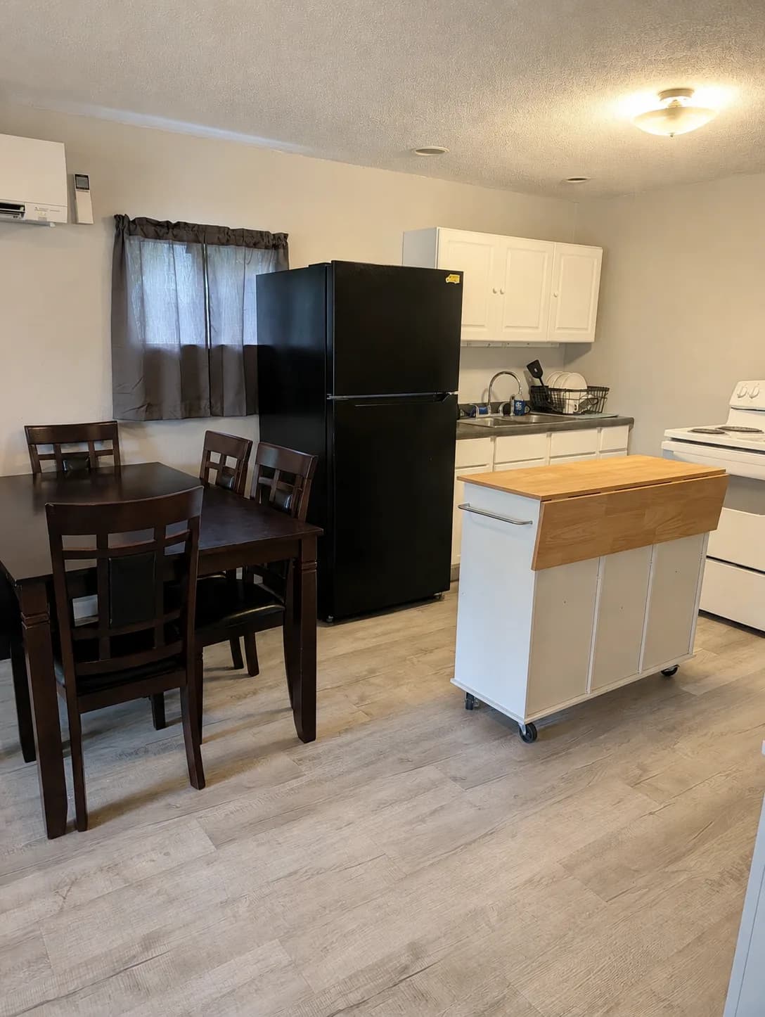 Suite dining table for four beside the kitchen